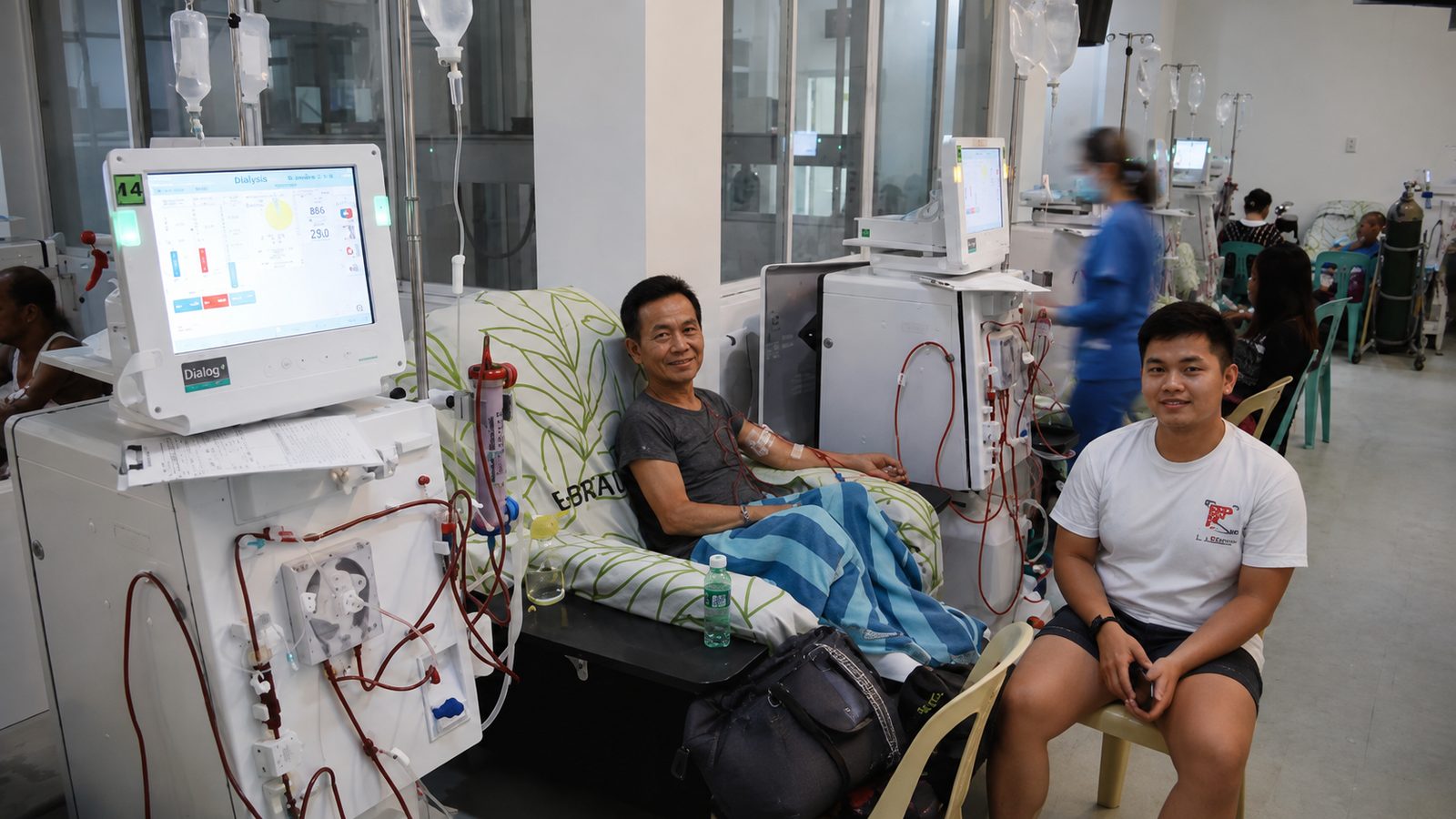 A dialysis clinic during a treatment shift. Patients receive treatment at assigned stations while clinic staff move between them.